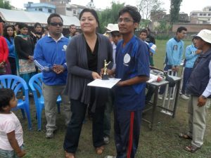 Awarding man of the match Troffy to lumbini's B3 Captain Khimananda Gaire by Punam Karmcharya