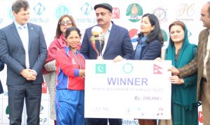 Nepal's captain Bhagwati Bhattarai receiving the winner's trophy